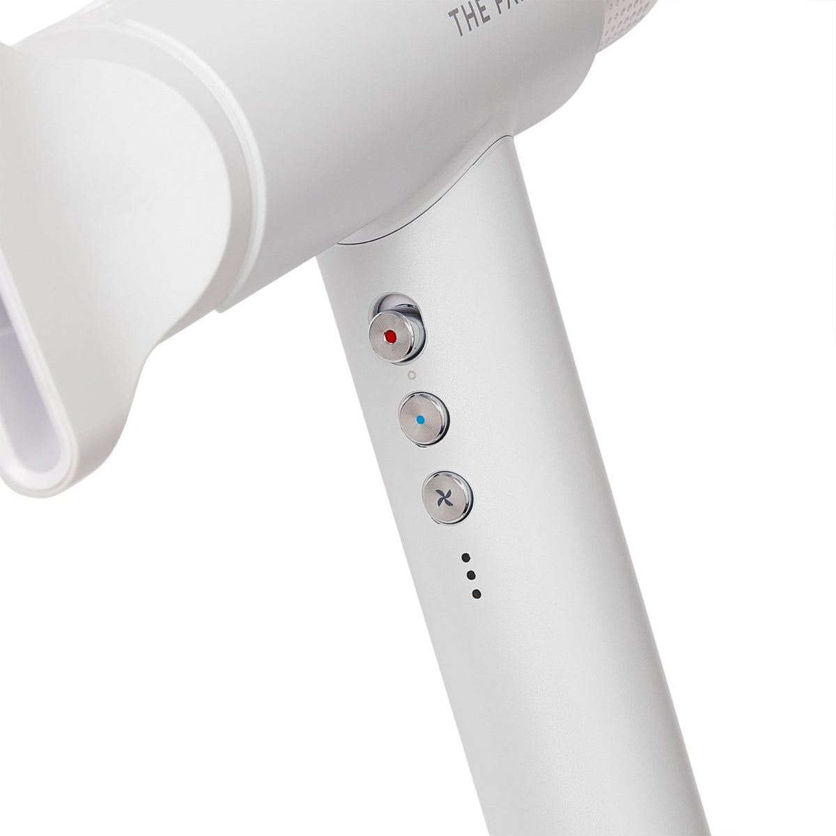 closeup of the buttons on the handle of a white hair dryer 